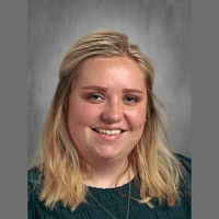 Katelynn Lawson, Bethany Alumni, against gray studio background at Bethany Lutheran College.