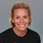 Laura Evans, Head Coach Volleyball and SFC Office Admin for the Athletics Department, standing in front of a black backdrop.