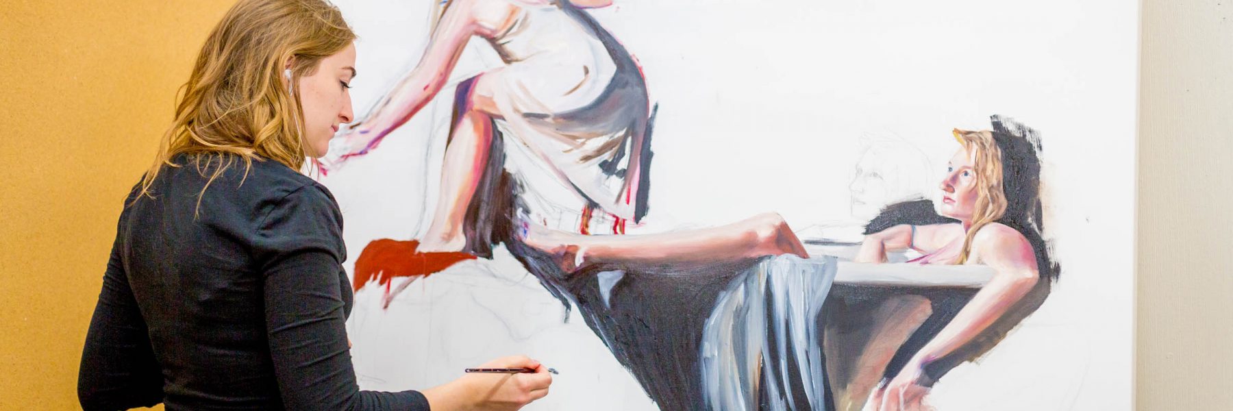 A woman in Minnesota paints a large canvas depicting two women in draped clothing, with one sitting and the other reclining.
