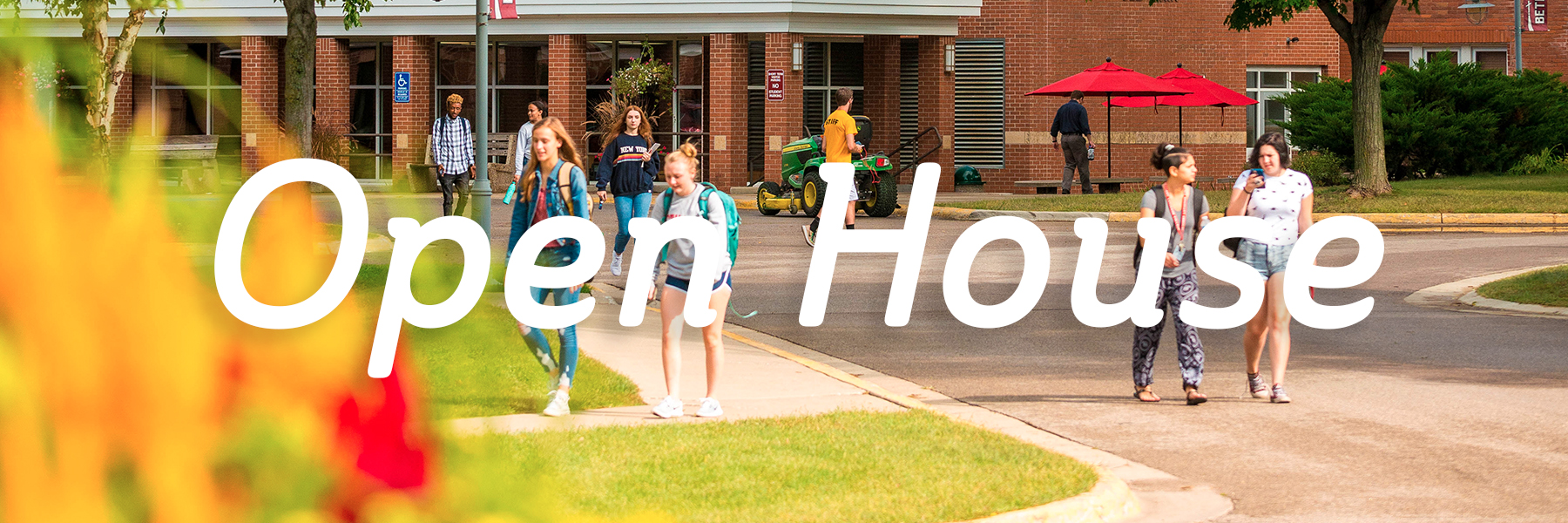 Students and adults walk outside a school building at Bethany Lutheran College, illustrating the campus community.