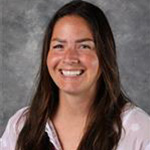 Alanna Lienig, Associate Professor for the Education Department, posing in front of a gray mottled background at Bethany Lutheran College.