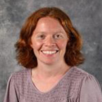 Allison Petzel, Online Instruction for the Biology Department, posed in front of a gray background.