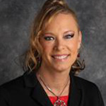 Angie Phares, Director of Career Development for the Career Services Department, against a grey backdrop.