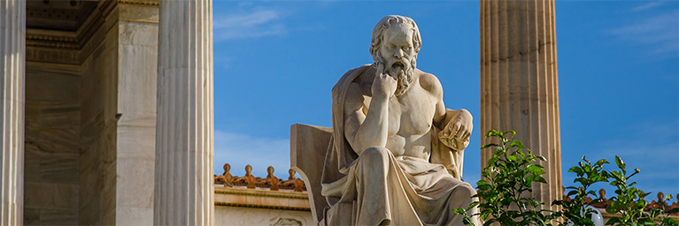 Marble statue of a seated philosopher, possibly Socrates, displayed on the Minnesota campus.