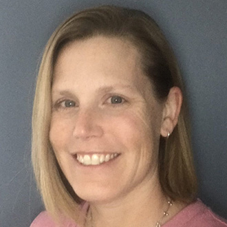 Smiling woman with straight blonde hair wearing a pink top, symbolizing student engagement at Bethany Lutheran College.