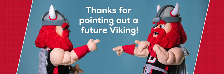 Two Viking mascots with red beards point at each other beneath text celebrating Bethany Lutheran College’s campus community.