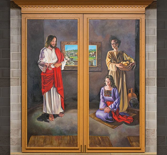 A painted scene depicts Jesus indoors with two women: one standing and holding a basket of fruit, the other kneeling on a mat.