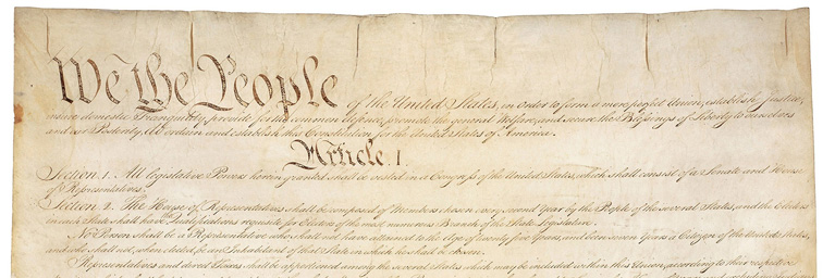 A close-up image of the top section of the U.S. Constitution on display at Bethany Lutheran College, prominently featuring We the People and Article I.
