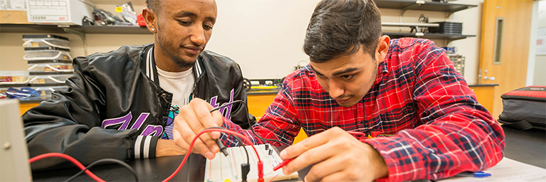 Two students at Bethany Lutheran College collaborate on a circuit board project, demonstrating active engagement.