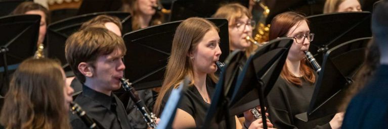 Bethany Lutheran College students in black attire perform clarinets as part of an ensemble in Mankato, Minnesota.