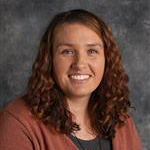 Brittany Espinoza, Assistant Professor for the Mathematics Department, against a grey background.