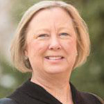 Carrie Pfiefer, Professor of Education for the Education Department, stands outdoors on the Minnesota campus.