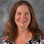 Cheryl Clendenin, Professor for the Nursing Department, stands in front of a gray background at Bethany Lutheran College.