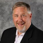 Don Westphal, Director of The Bethany Fund for the Advancement Department, against a gray background.