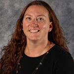 Estelle Vlieger, Director of Admissions for the Admissions Department, atop a gray background.