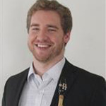 Evan Bierer, Director of Jazz Band and Lessons Instructor for the Music Department, against neutral background.