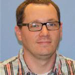 Jeremy Jacob, Director of Network Systems for the Information Technology Services Department, against a blue backdrop.