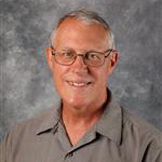 Jon Bunkowske, Technician for the Maintenance Department, poses in front of a mottled background.