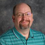 Jon Loging, Associate Professor for the Communication Department, teaching a classroom.