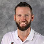 osh Peterson, Director of Human Resources for the Human Resources Department, in front of a gray mottled background.