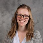 Katelyn Bolte, Instructor for the Psychology Department, against gray backdrop.