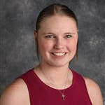 Kristen Flathers, Counselor for the Admissions Department, against a gray backdrop.