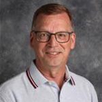 Lance Schwartz, Chief Communication Officer for the Institutional Communication Department, against a gray background.