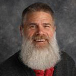 Lars Johnson, Professor for the English Department, set on a gray background.