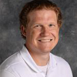 Lucas Seehafer, Assistant Professor for the Exercise Science Department, against a gray background.