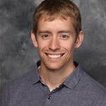 Nick Cook, Director of International Partnerships for the Admissions Department, set against a gray background.