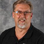Pat Hull, Director of Facilities for the Facilities Department, against grey background.
