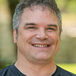 Perry Conrad, Resident Hall Coordinator for the Residential Life Department, stands outdoors on the Bethany Lutheran College campus.