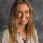Rachel Kerkow, International Student Coordinator for the Student Affairs Department, posed against a gray mottled background.
