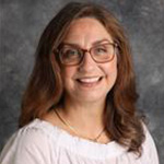 Sara Bloedel, Data Entry and Office Assistant for the Education Department, against a gray background.
