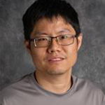 Sheng Sang, Assistant Professor for the Engineering Sciences Department, against a gray background.