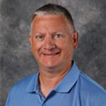 Todd Marzinske, Director of Administrative Computing and Institutional Reporting for the Information Technology Services Department, poses on grey background