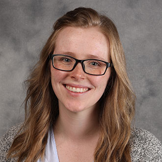 Katelyn Bolte, Instructor for the Psychology Department, in front of a gray background.