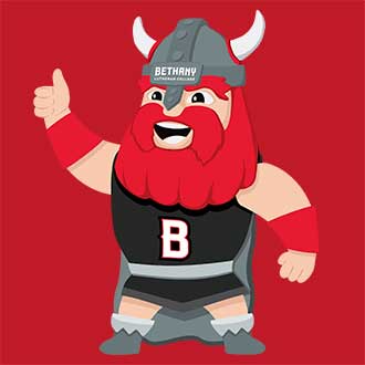 Cartoon Viking mascot of Halvar with a red beard, wearing a horned helmet and a shirt featuring a B on the chest, gives a thumbs-up gesture.