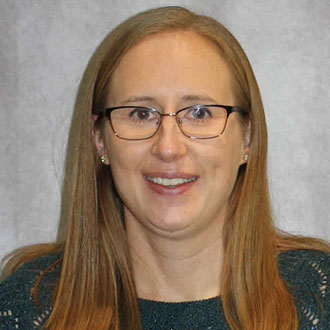 Kelly Holtz, Adjunct Faculty for the Nursing Department, in front of a plain light background.