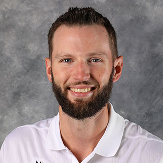 Josh Pederson, Director of Human Resources for the Human Resources Department, smiles in front of a gray background.
