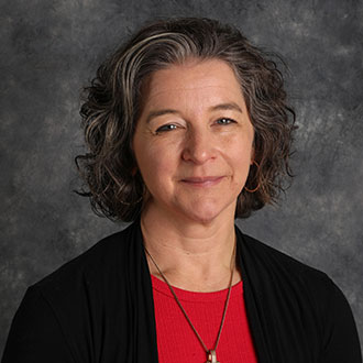 Jenna Thompson, Fine Arts Center Event Coordinator for the Academic Affairs Department, smiles slightly against a gray background.