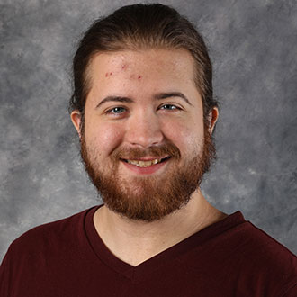 Colin Trueblood, Housekeeping Technician of the Housekeeping Department, smiles at the camera.