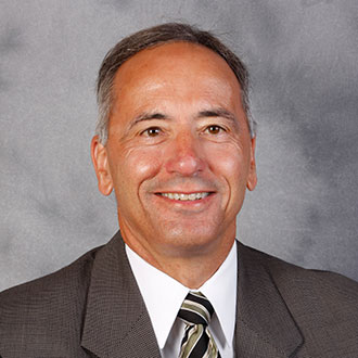 Art Westphal, Senior Development Officer, stands against a gray background.