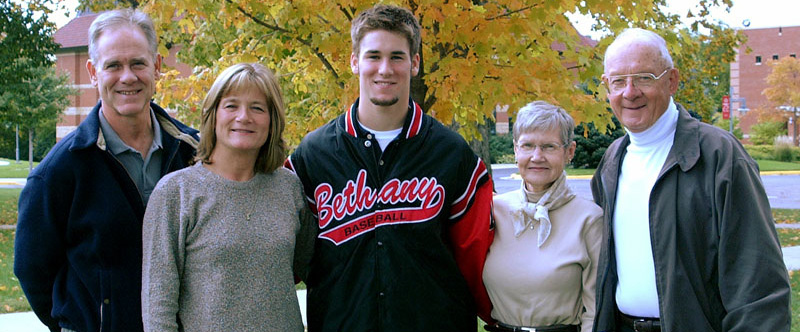 Six students pose outdoors in front of autumn trees at Bethany Lutheran College, Minnesota.