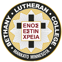 Bethany Lutheran College seal featuring a central cross, Greek text, and Mankato Minnesota around the border—used for students.