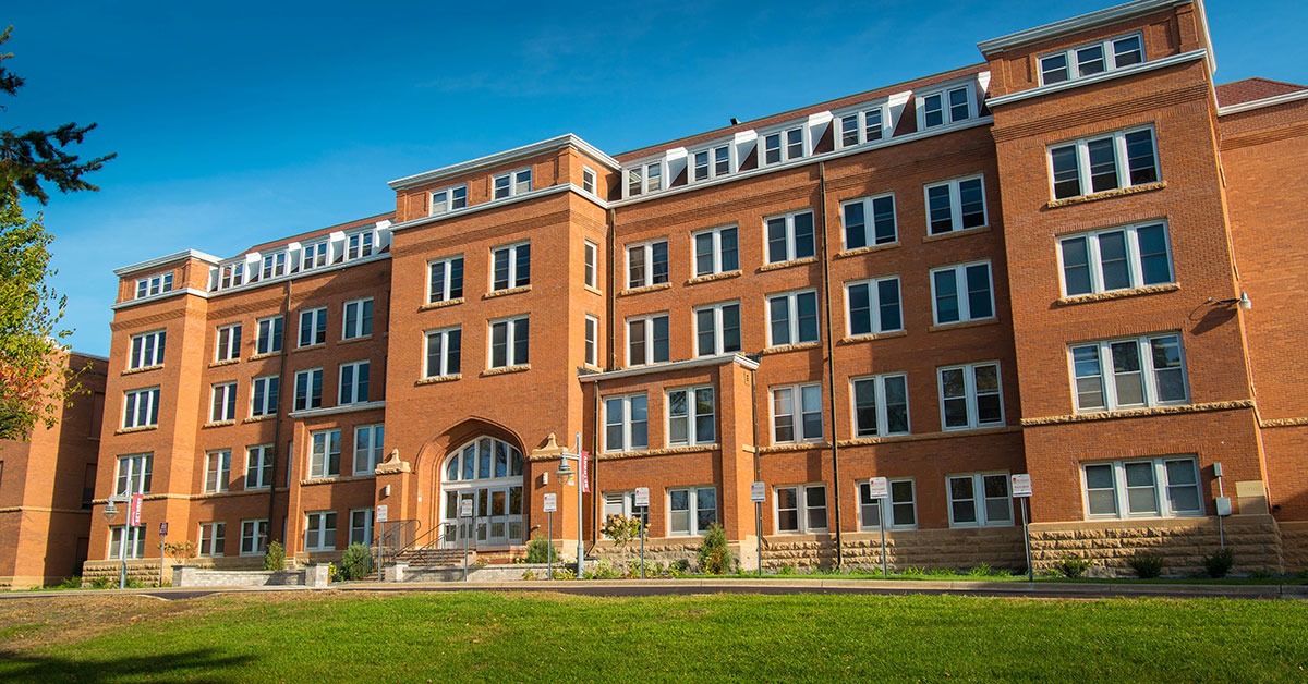 Old Main building at Bethany Lutheran College with blue sky.