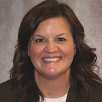 Shannon Reichel, Office Assistant for the Advancement Department, against a grey background.