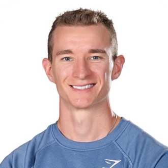 Person smiling in a blue shirt with a white background.