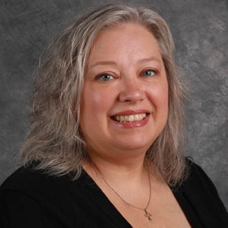 Stephanie Schmid, Admissions Processing for the Admissions Department, against a grey background.